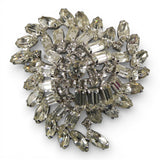 Decorative brooch with crystal-like stones on a white background