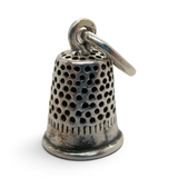 Brocosi.com antiqued sterling silver thimble charm with a textured pitted surface and polished silver band.