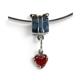 Brocosi.com sterling silver present charm bead with a hanging red heart charm on a silver bangle bracelet.