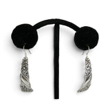 Brocosi.com sterling silver dangle earrings featuring a curved Victorian scroll design on a black display stand.