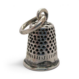 Brocosi.com vintage sterling silver thimble charm with pitted texture and polished band on a jump ring